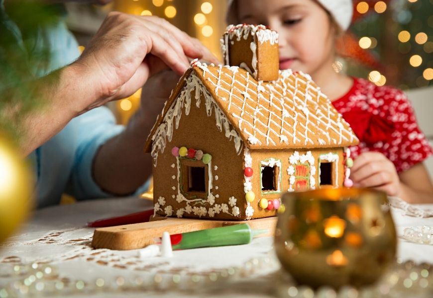 building a gingerbread house with child