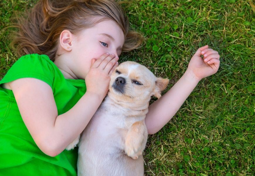 girl whispering to her dog