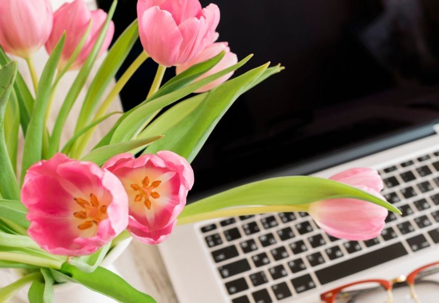 flowers next to laptop