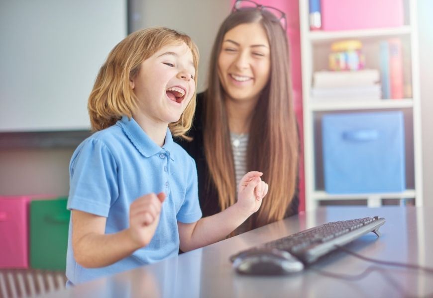 young girl laughs during online learning