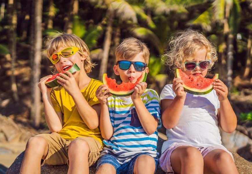 children eating watermelon in summer